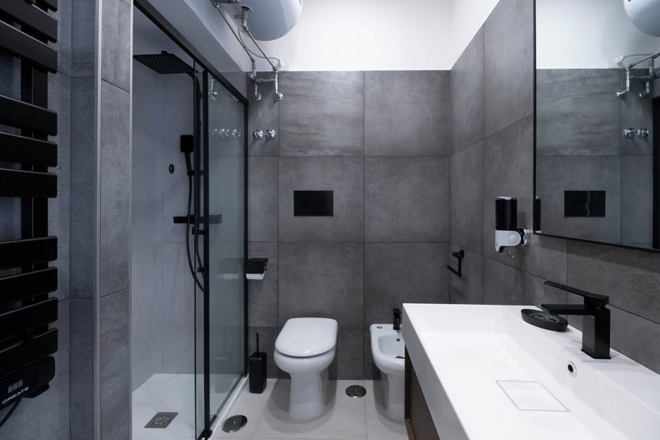 Family Suite, Balcony, City View | Bathroom | Shower, rainfall showerhead, hair dryer, towels