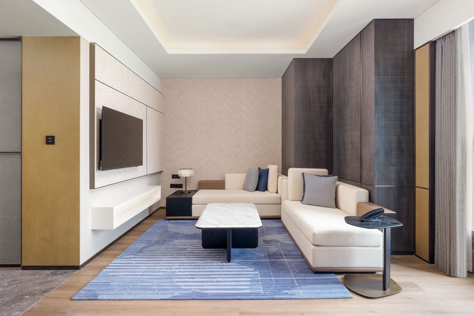 Deluxe Suite, 1 Bedroom | Living area | 55-inch LCD TV with cable channels