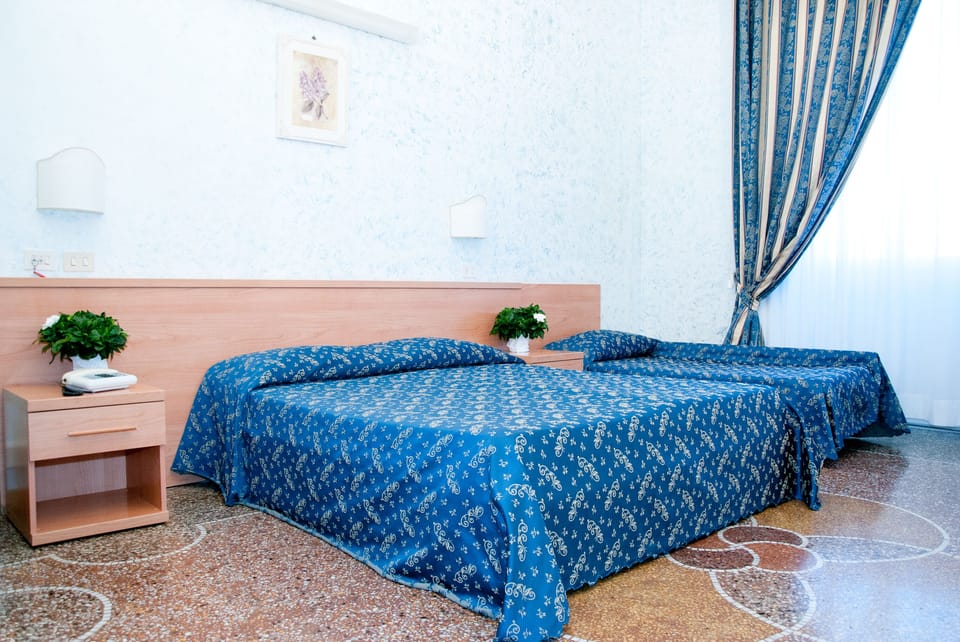 Standard Triple Room | Minibar, in-room safe, desk, blackout drapes