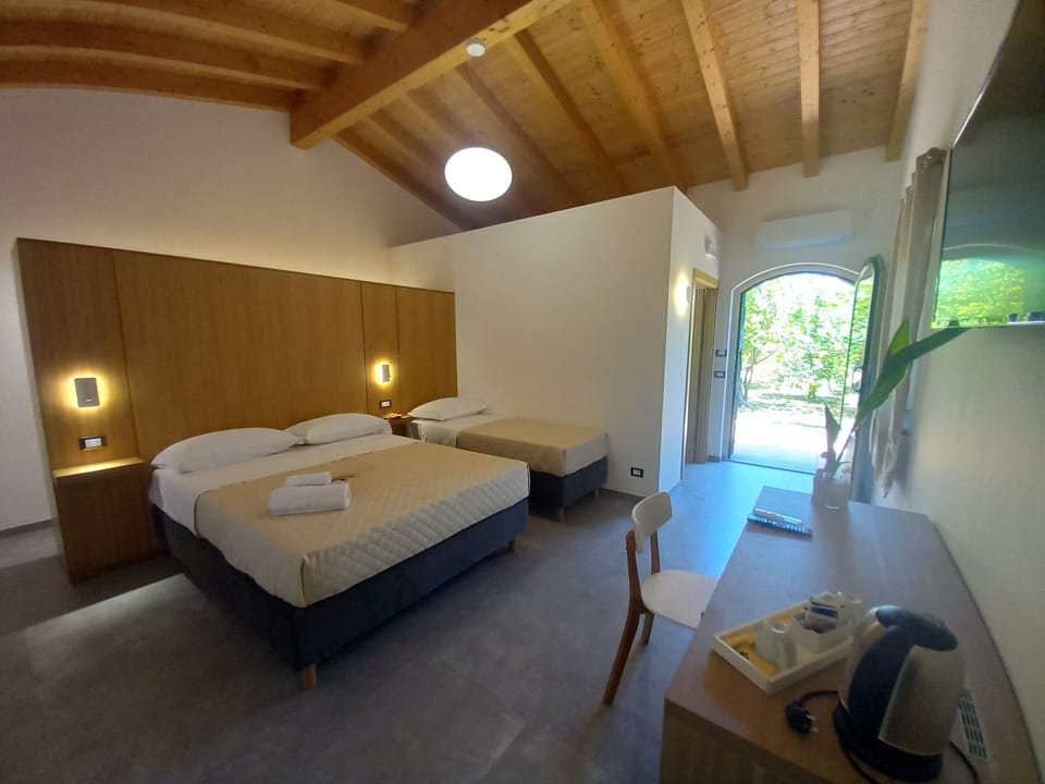 Triple Room, Garden View | Desk, free cribs/infant beds, free WiFi, bed sheets