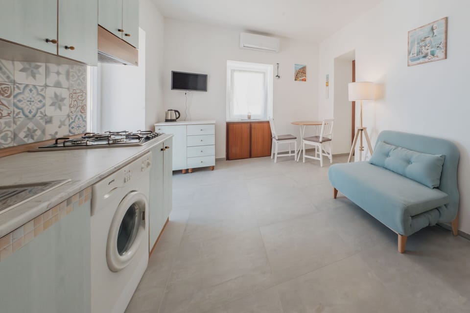 Apartment, Sea View | Living area | 32-inch flat-screen TV with cable channels