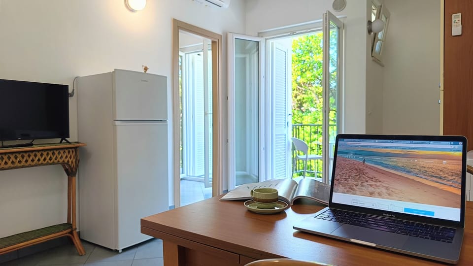 Apartment, Partial Sea View | Living area | TV