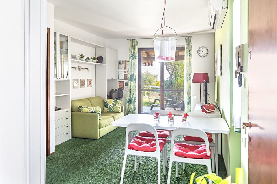 Apartment, Garden View | Living area | 35-cm TV with digital channels