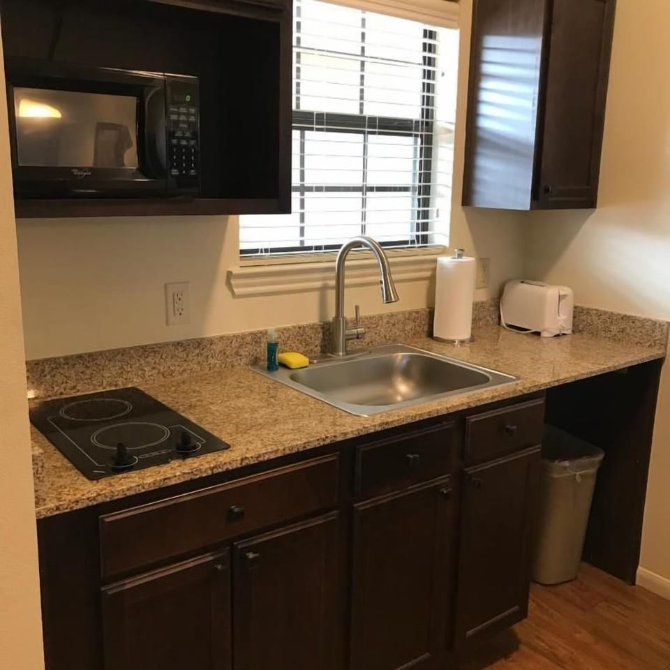 Full-size fridge, microwave, stovetop, cookware/dishes/utensils