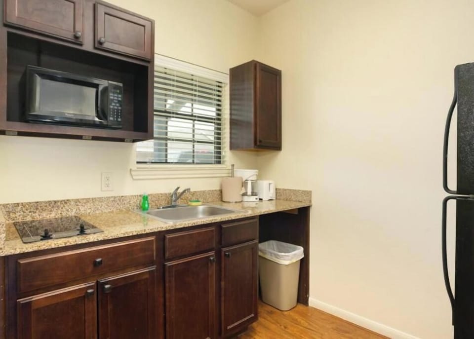 Full-size fridge, microwave, stovetop, cookware/dishes/utensils