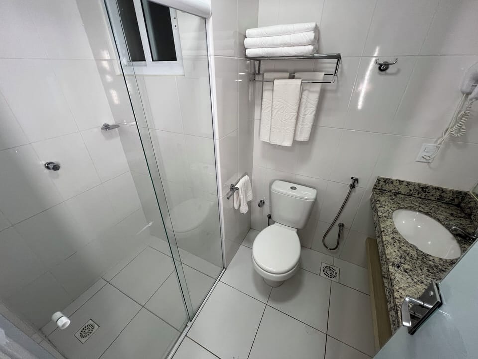 Standard Room | Bathroom | Shower, towels, toilet paper