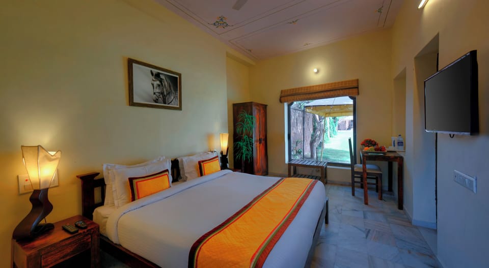 Deluxe Room, Garden View | 1 bedroom, desk, laptop workspace, soundproofing