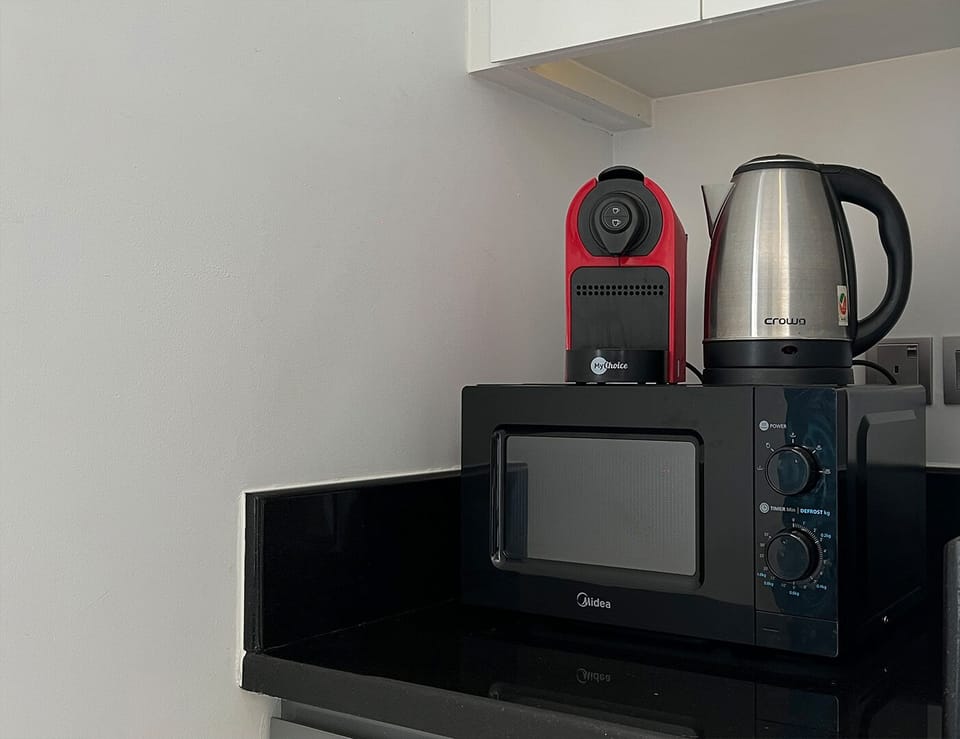Deluxe Studio, 1 Double Bed, City View | Private kitchen | Fridge, microwave, oven, stovetop