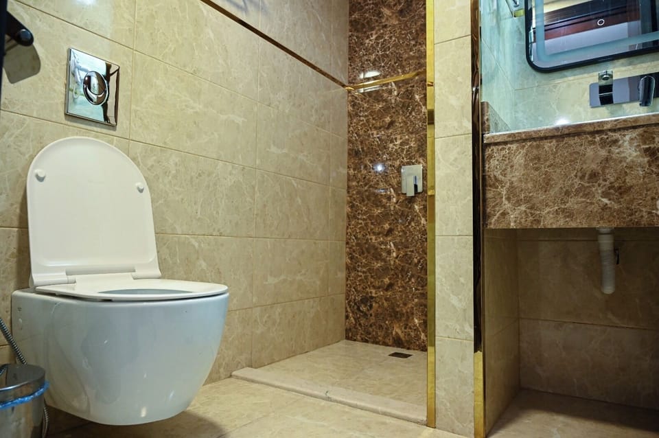 Suite, 1 King Bed | Bathroom | Hair dryer, slippers, towels, soap
