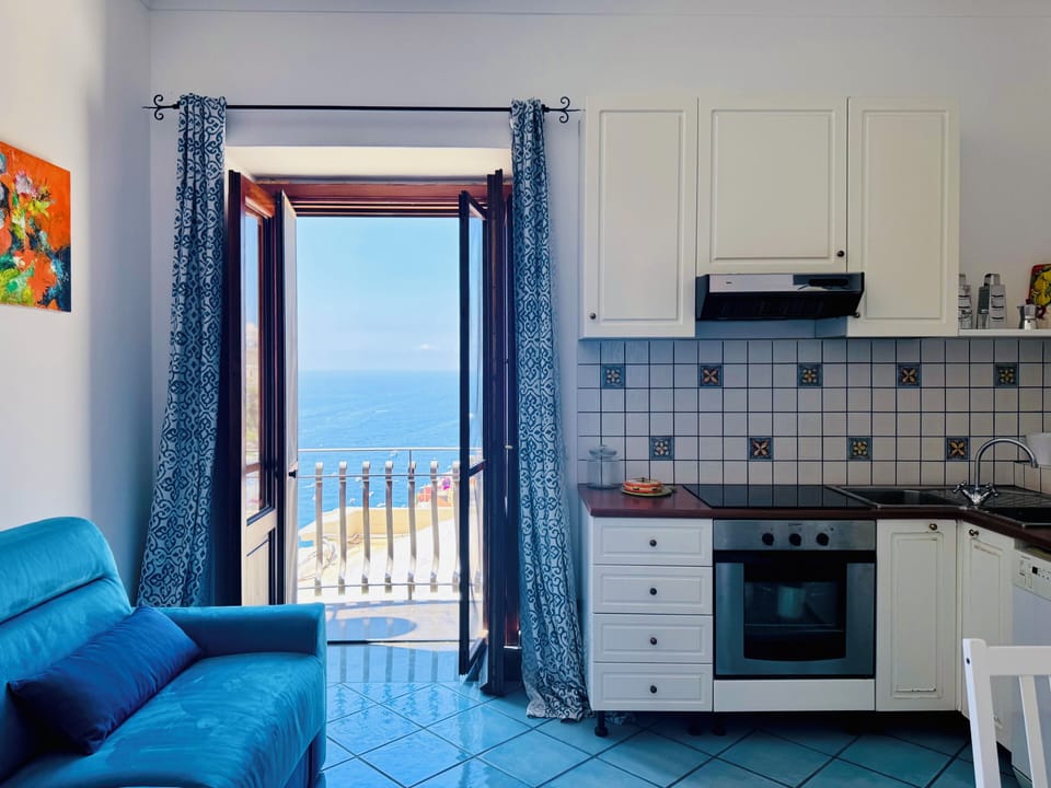 Apartment, Sea View | Living area | 20-inch flat-screen TV with digital channels