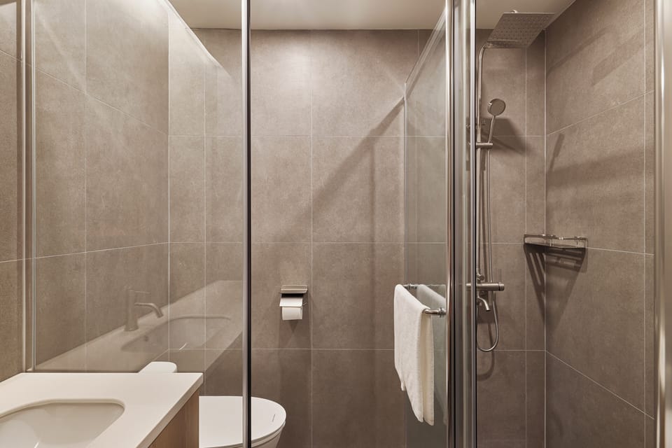 B (Single Bed 4) | Bathroom | Shower, hair dryer, slippers, towels