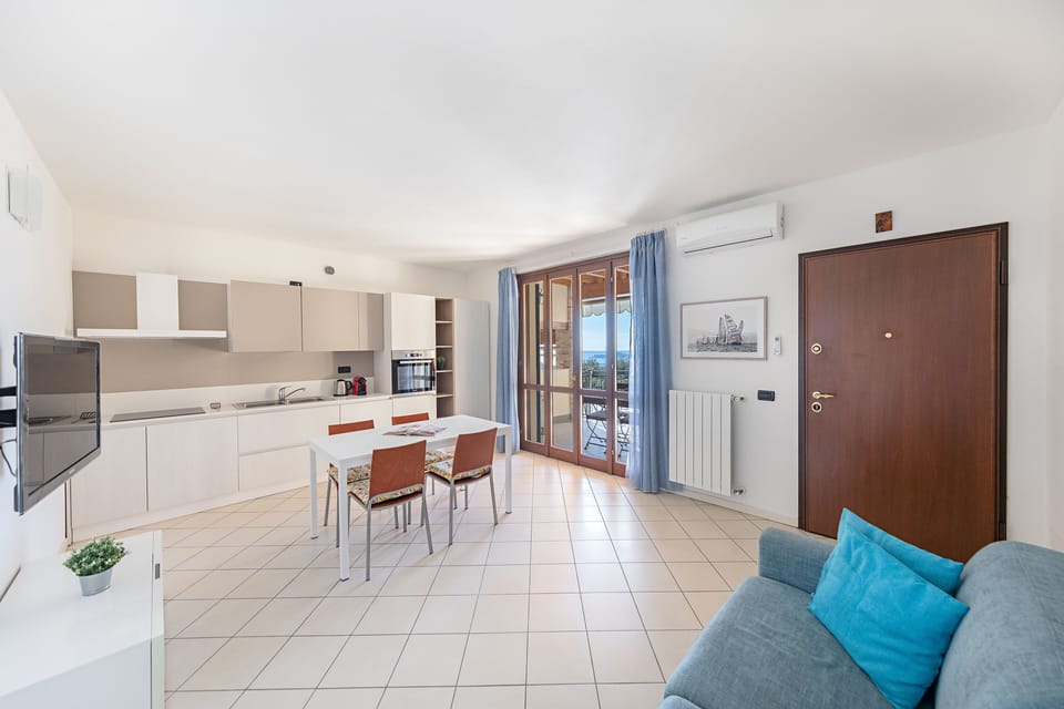 Apartment, Balcony, Partial Lake View | Living area | 35-inch flat-screen TV with digital channels
