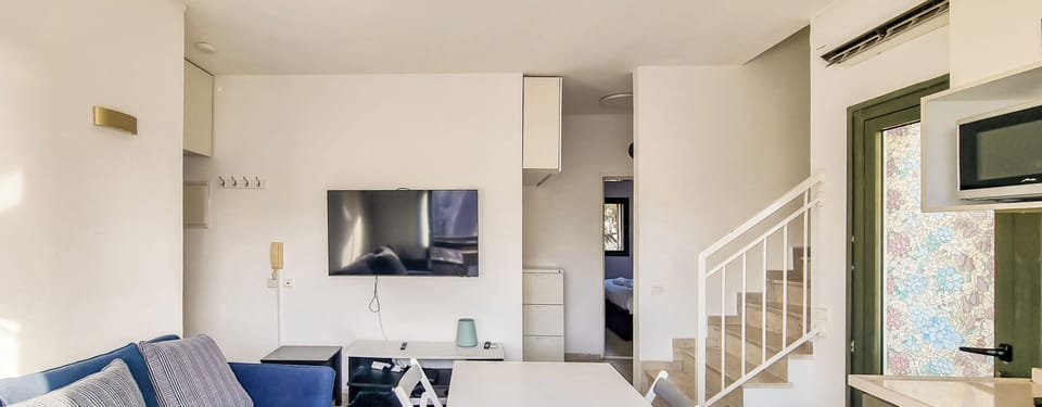Apartment | Living area | 65-inch flat-screen TV with cable channels