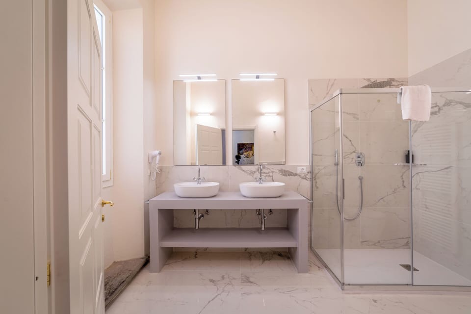 Quadruple Room | Bathroom | Shower, hair dryer, towels, soap