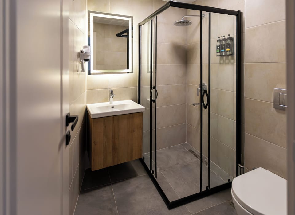 Shower, hair dryer, slippers, towels