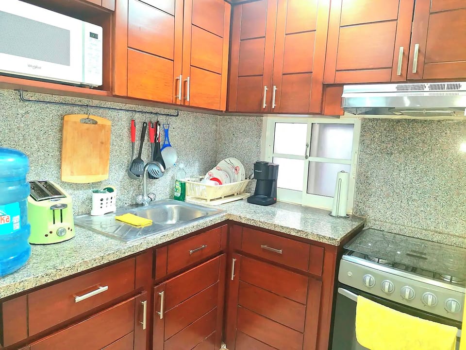 Full-size fridge, microwave, coffee grinder, cookware/dishes/utensils