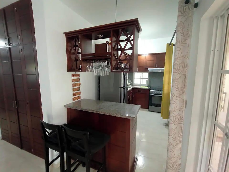 Full-size fridge, microwave, coffee grinder, cookware/dishes/utensils