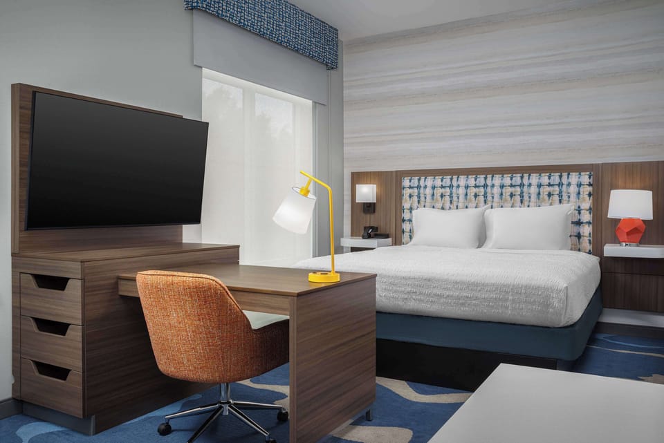 Desk, laptop workspace, blackout drapes, bed sheets