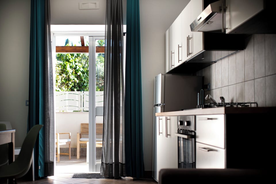 Poseidonia | Private kitchen | Stovetop, highchair, cookware/dishes/utensils, cleaning supplies