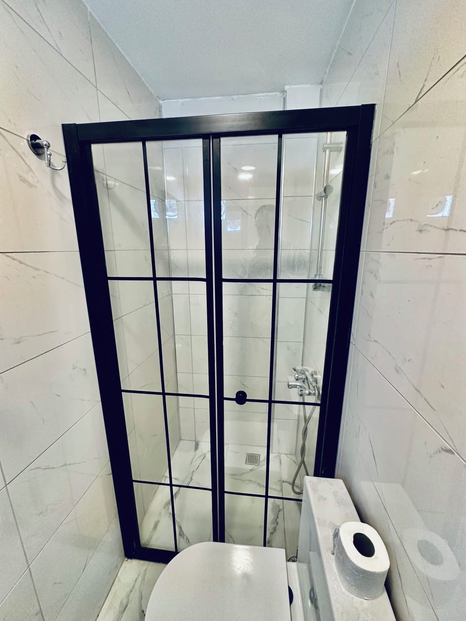 Shower, hair dryer, slippers, towels