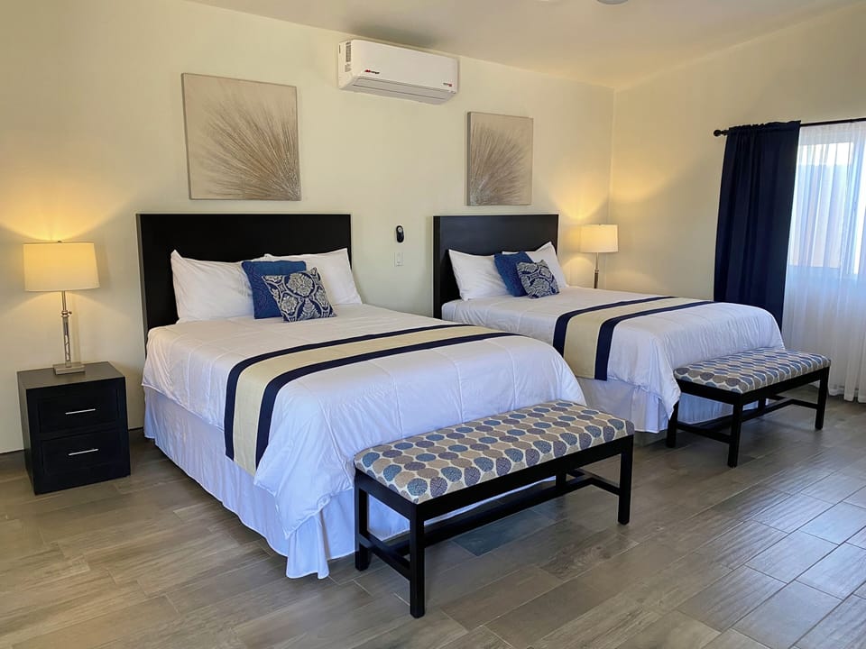 Deluxe Quadruple Room | Minibar, blackout drapes, iron/ironing board, free WiFi