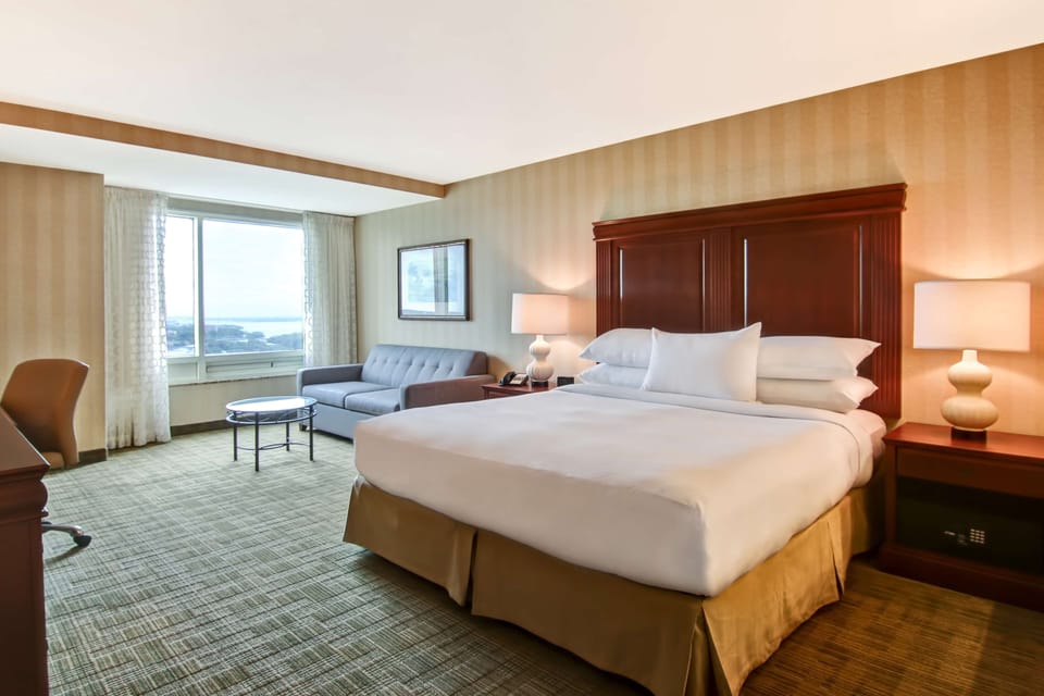 Premium Room, 1 King Bed, Soaker Tub, US Falls View | Living area | 55-inch flat-screen TV with satellite channels, TV