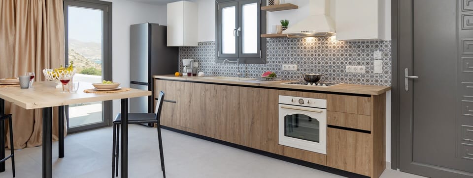 Deluxe Apartment | Private kitchen | Espresso maker, coffee/tea maker, electric kettle, highchair