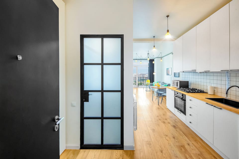 Apartment, Balcony, City View | Private kitchen | Electric kettle, dining tables