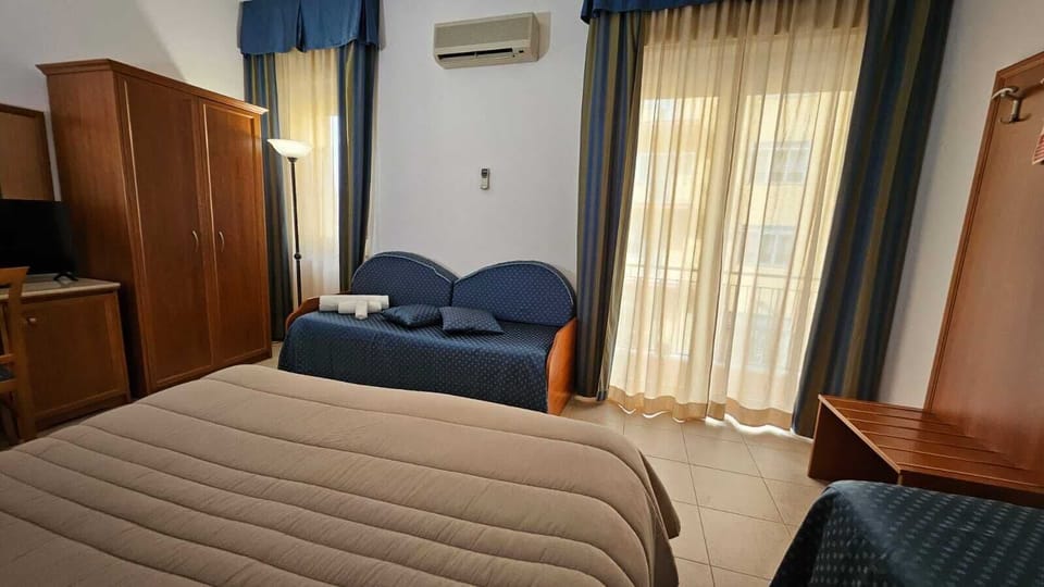 Classic Quadruple Room, Balcony | In-room safe, free WiFi, bed sheets