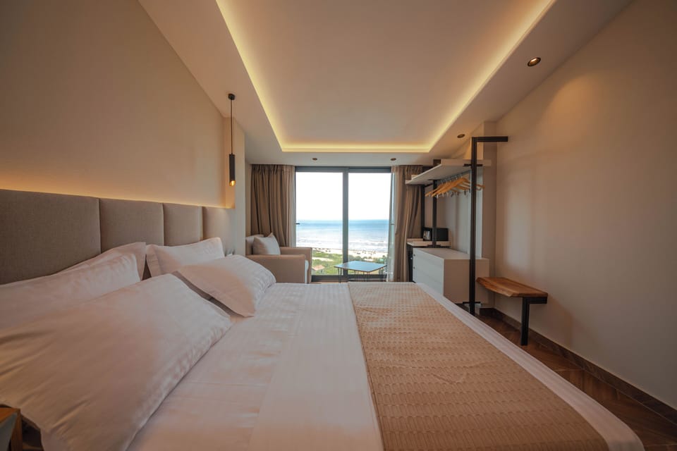 Deluxe Triple Room, Sea View | Minibar, in-room safe, desk, blackout drapes