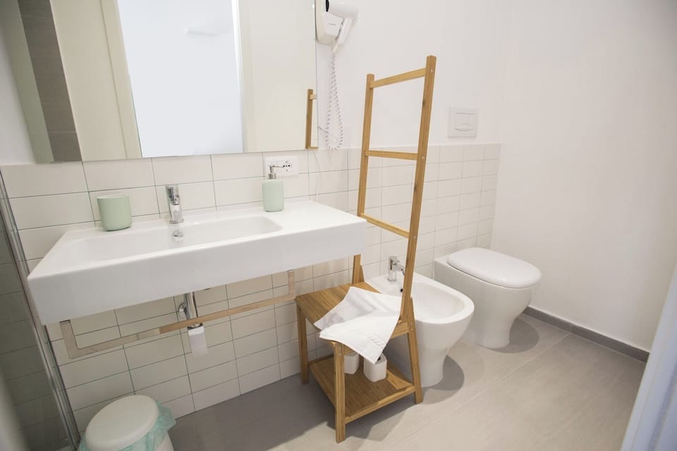 Triple Room, Balcony, City View | Bathroom | Shower, hair dryer, bidet, towels