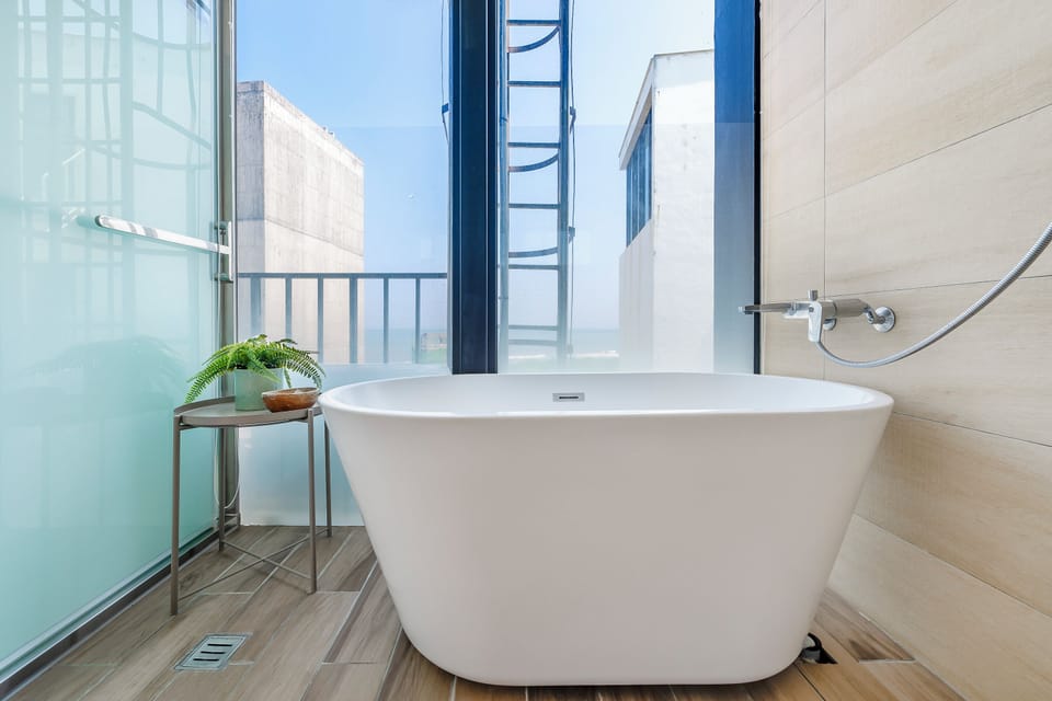 Separate tub and shower, hair dryer, slippers, towels