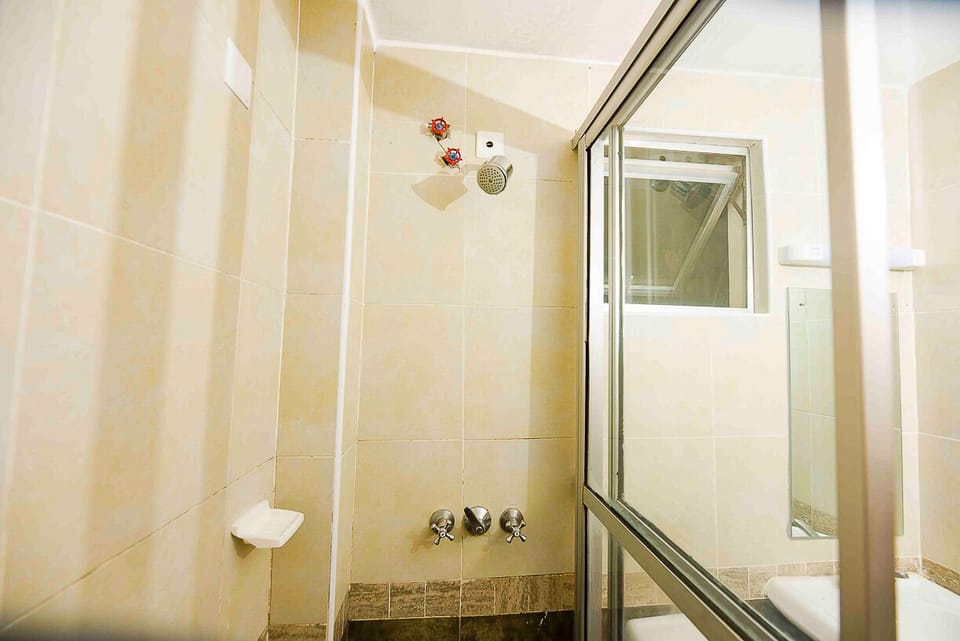 Shower, rainfall showerhead, slippers, towels