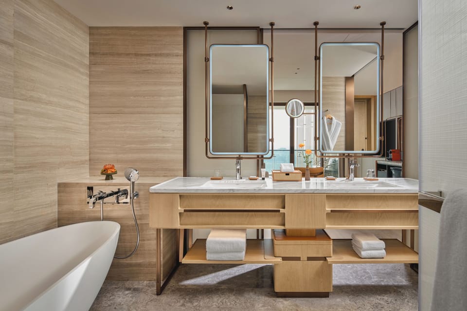 Deluxe Suite | Bathroom | Designer toiletries, hair dryer, bathrobes, slippers