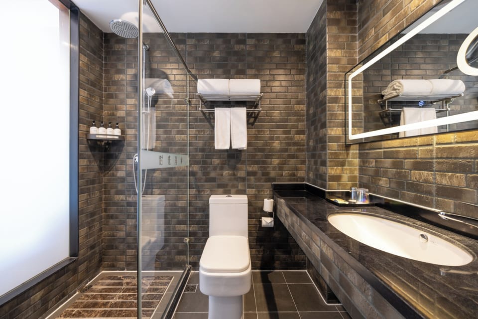 Shower, designer toiletries, hair dryer, towels
