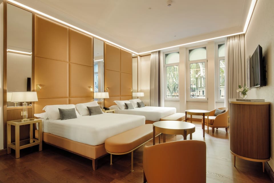 Deluxe Quadruple Room | Minibar, in-room safe, desk, blackout drapes