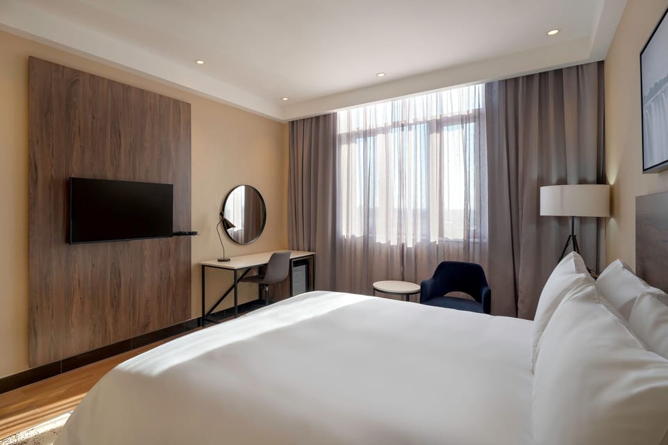 Room, 1 King Bed, Garden View | Minibar, desk, laptop workspace, blackout drapes