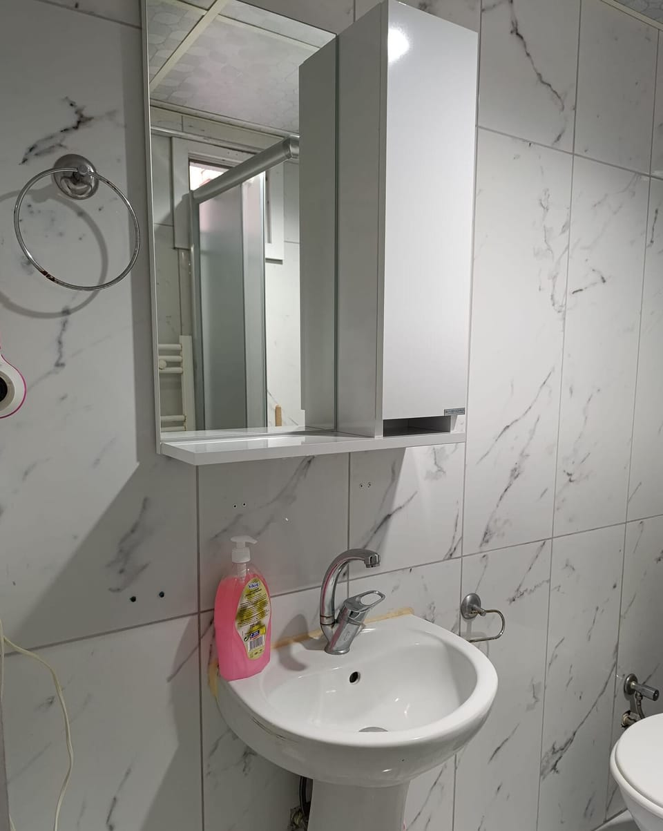 Shower, hair dryer, slippers, towels