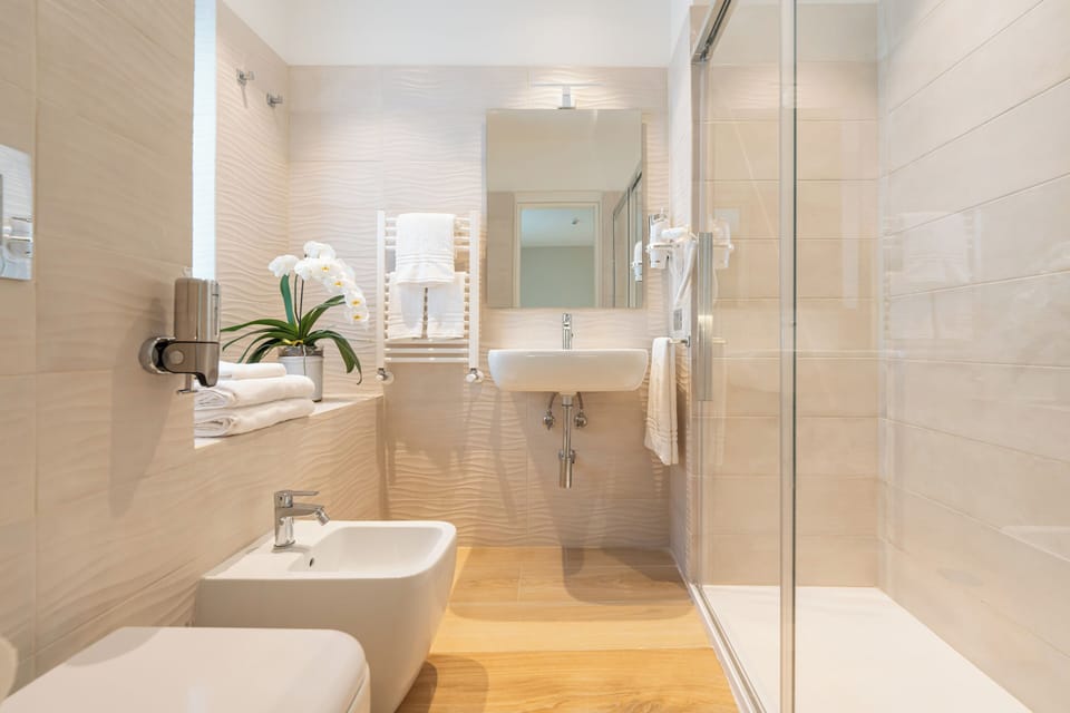Family Quadruple Room | Bathroom | Shower, hair dryer, towels, soap
