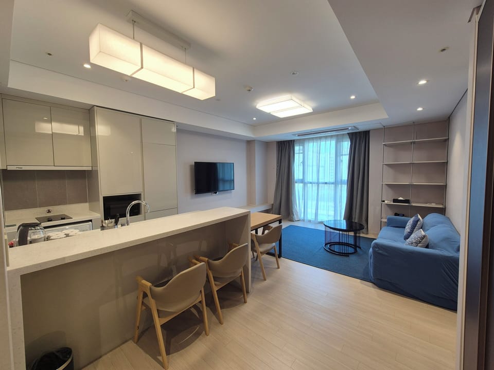 Residence connecting suite room | Living area | 96-cm TV with cable channels, printers