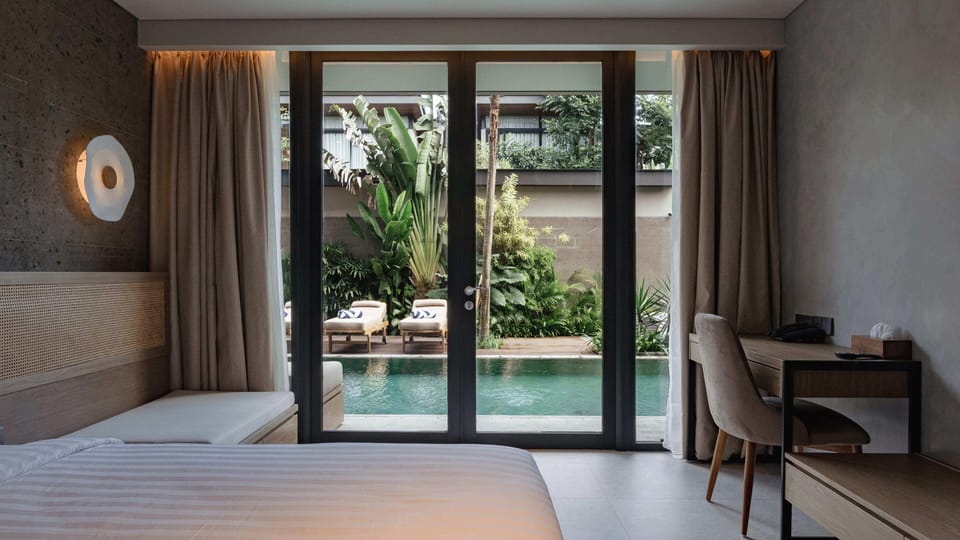 Deluxe Corner Pool Access | Minibar, in-room safe, desk, blackout drapes