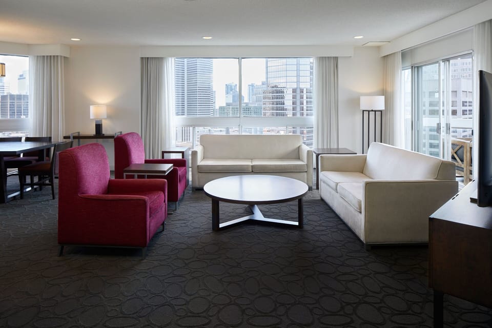 Club Suite, 1 Bedroom, Non Smoking | Living room | 42-inch LCD TV with digital channels, TV, iPod dock