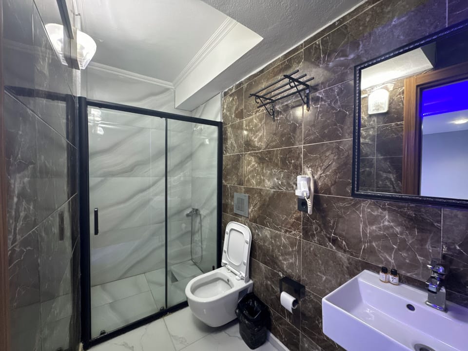 Shower, hair dryer, slippers, towels