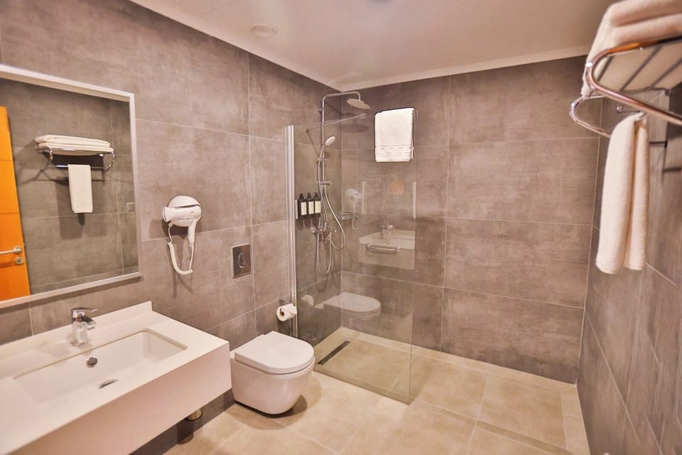 Shower, hair dryer, slippers, towels