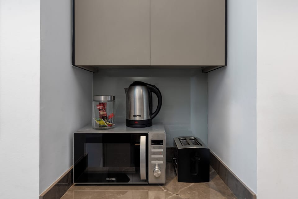 Deluxe Studio, Balcony, City View | Private kitchen | Fridge, microwave, oven, stovetop