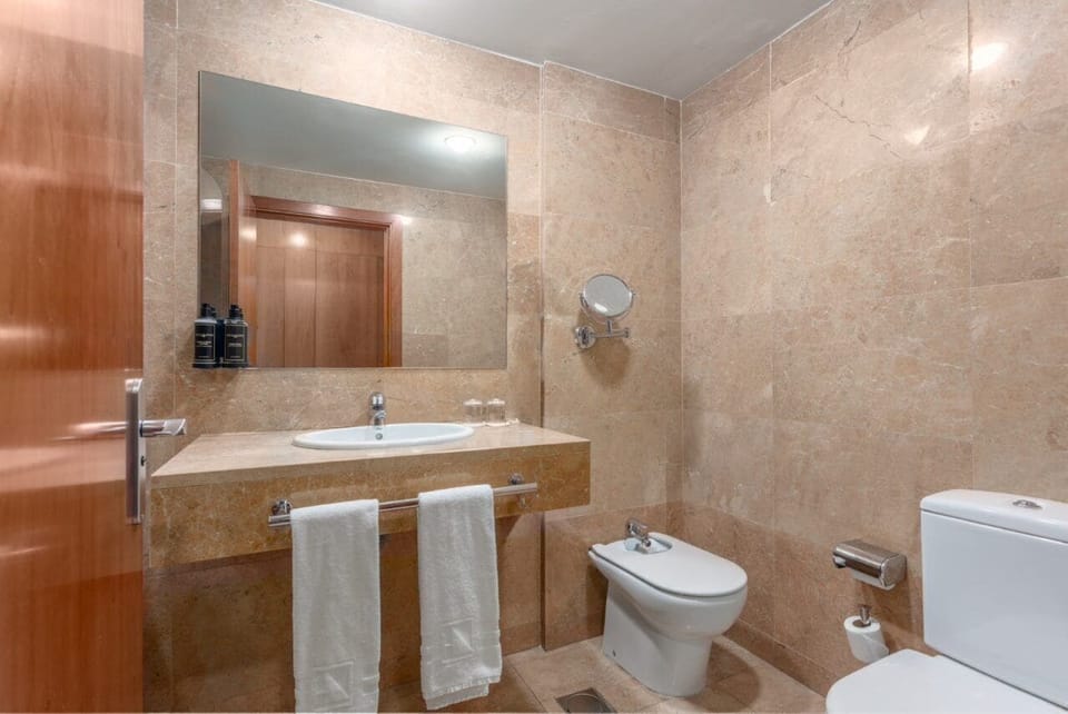 Bathtub, eco-friendly toiletries, hair dryer, bidet
