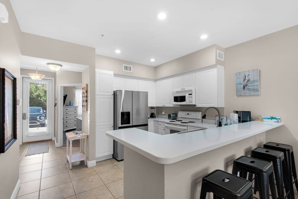 Condo, Multiple Beds, Patio, Garden View (The Village Unit 412) | Private kitchen | Fridge, microwave, oven, stovetop