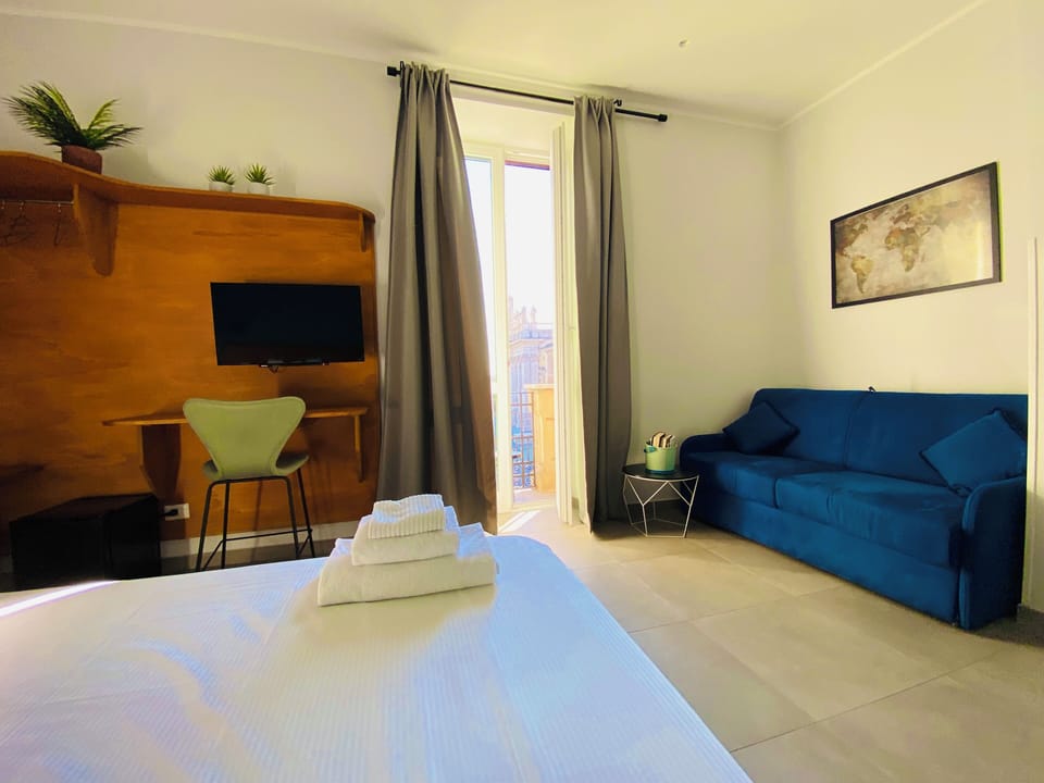Deluxe Quadruple Room, Balcony, City View | Hypo-allergenic bedding, minibar, desk, laptop workspace