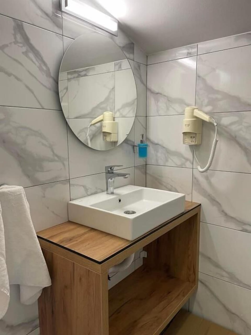 Shower, hair dryer, slippers, towels
