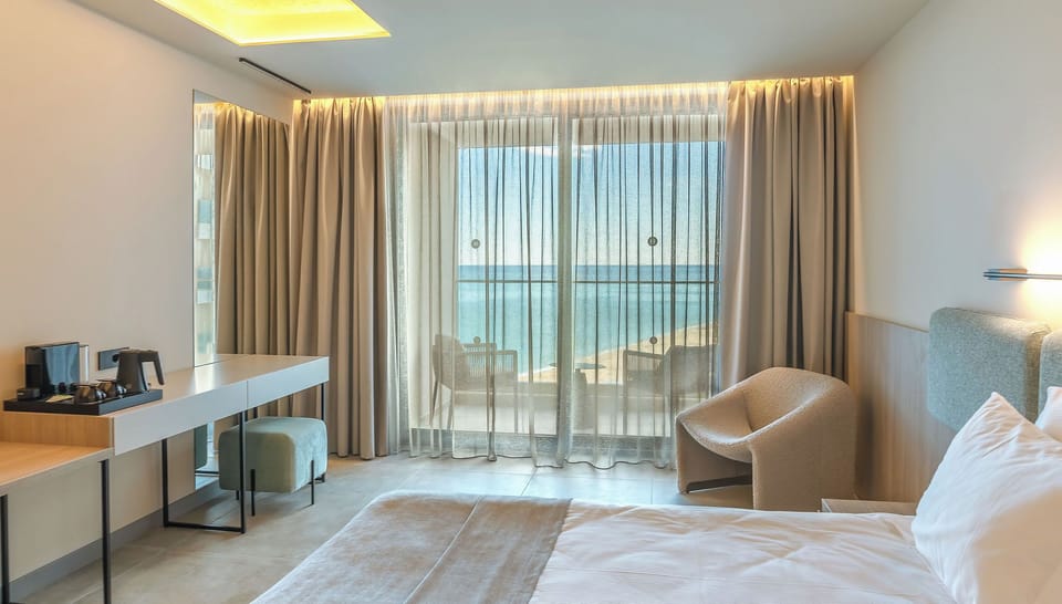 Deluxe Double Room, Balcony, Sea View | Minibar, in-room safe, desk, laptop workspace
